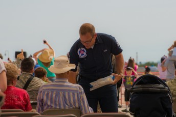 A member of the Thunderbird's crew hands out souvenirs to guests. 