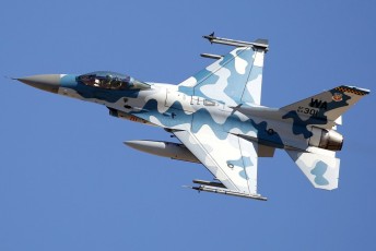 A Red Air F-16C Aggressor makes a sharp, high speed bank as it heads out to the NTTR.