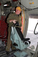CC-130 Hercules Flight Engineer MCpl Mike Huggie at the starboard spotter position.