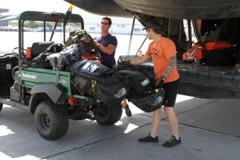 SAT Technicians load their gear into the CC-130 Hercules prior to their SAR training mission.