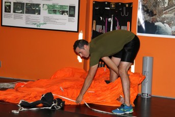 SAR Tech packing his training parachute.