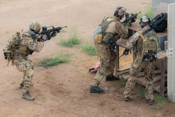 Specialists from the Luftwaffe Kampfretter (German CSAR specialists) return fire to fight off an insurgency during an Angel Thunder 2015 mission 