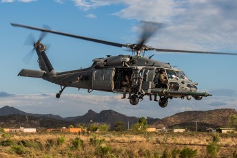 A USAF HH-60G Pave Hawk departs after securing personnel during a rescue mission as part of Angel Thunder 2015