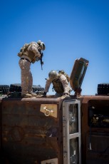 Marines from 1st Force Recon Co. check the disabled MRAP for survivors