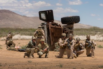 A multinational force awaits rescue  from an IED strike on their MRAP