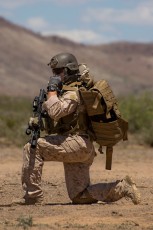 "All Clear" - A Marine from 1st Force Recon Co. communicating with fellow Marines during a rescue mission