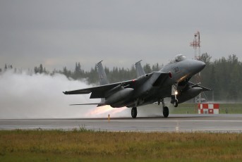 A  Mitsubishu F-15J Eagle of the JASDF 203rd Tactical Fighter Squadron launches for its Red Flag mission in heavy, horizontal rain.