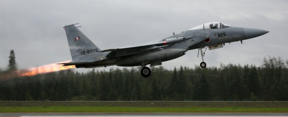 A  Mitsubishu F-15J Eagle of the JASDF 203rd Tactical Fighter Squadron launches for its Red Flag mission in heavy, overcast skies.