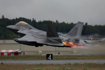 This Lockheed Martin F-22A Raptor launched in heavy weather from JBER with wing tanks and full afterburners.