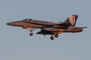 The star aircraft of WTI 1-16…A McDonnell Douglas F/A-18 Hornet from Marine Fighter Attack Squadron 122 (VMFA-122) “Crusaders” returns at sunset from a WTI 1-16 sortie. 
