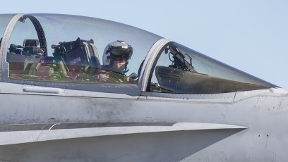 FA-18D of VFMA (AW)-225 Vikings of MCAS Miramar taxis to mission launch at NAS Fallon, with panel reflected in visor.