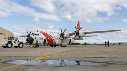 USCG HC-130J is moved to the hangar to repair damage from "fish strike."