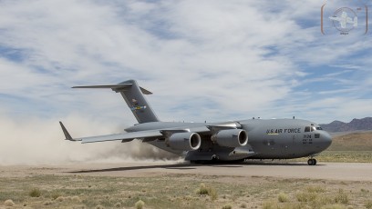 Air Mobility Command C-17A of the 436th AW/512 AW, Dover, DE kicks up the dust as it takes off from Keno Airfield on the NTTR during Joint Forcible Entry Exercise (June 2016).
