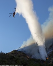 CH-54B empties the tank right onto the flames of the Azusa Fire on the hills North of Los Angeles June 20, 2016