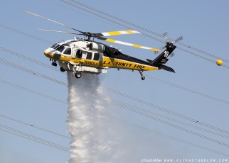 Sikorsky S-70A Firehawk making water drop on the Azusa Fire in close proximity to power transmission lines.  On the hills North of Los Angeles June 20, 2016