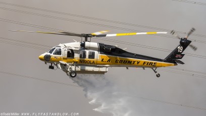 Sikorsky S-70A Firehawk making water drop on the Azusa Fire in close proximity to power transmission lines.  On the hills North of Los Angeles June 20, 2016