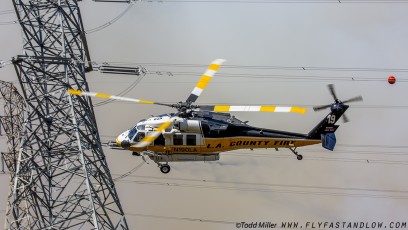 Sikorsky S-70A Firehawk skirts powerlines just after water drop on Azusa Fire, June 20, 2016.