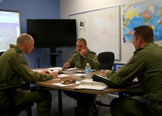 Maj. Hirt briefing Maj. Duffy and Capt. Atkinson on the training mission.