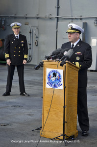 Rear Admiral John Alexander and Captain Timothy Kuehhas speak to a crowd aboard the USS George Washington