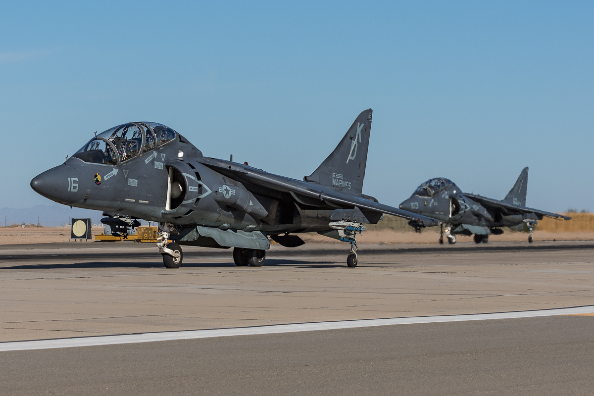 A pair of odd-looking USMC McDonnell Douglas TAV-8B Harrier II's from Marine Attack Training Squadron 203 (VMAT-203) "Hawks" taxis out for departure. 