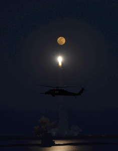 Delta-IV rocket "aiming" for the moon as a Pave Hawk flight crew looks on (U.S. Air Force photo/Lt. Col. Rob Haston)
