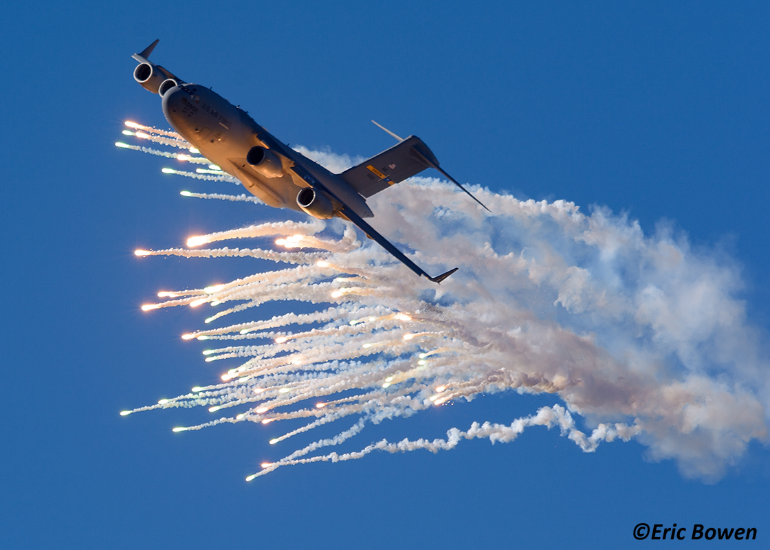 Air Mobility Command C-17A of the 437 AW/315 AW, Charleston, SC launches flares over Keno Airfield on the NTTR during Joint Forcible Entry Exercise (Dec. 2015).