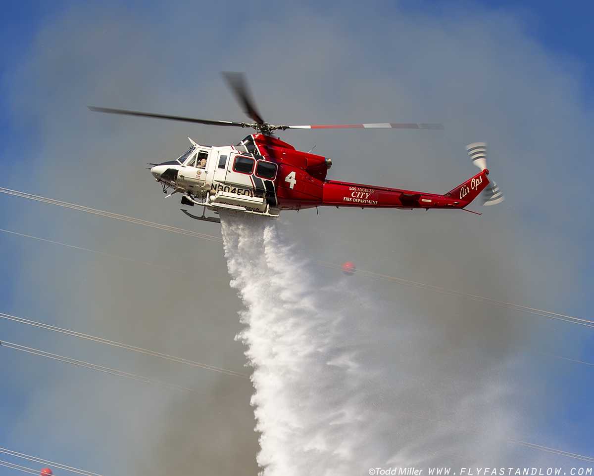 Bell 412EP of Los Angeles Fire Department makes water drop just inside power lines on the Azusa Fire on the hills North of Los Angeles June 20, 2016