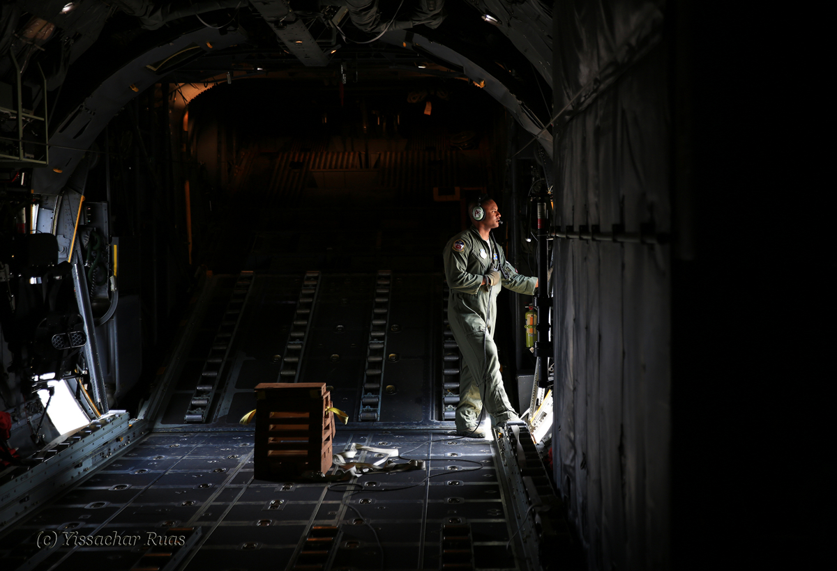 Staff Sgt. Wesley Brown, loadmaster looks out towards the runway before take off